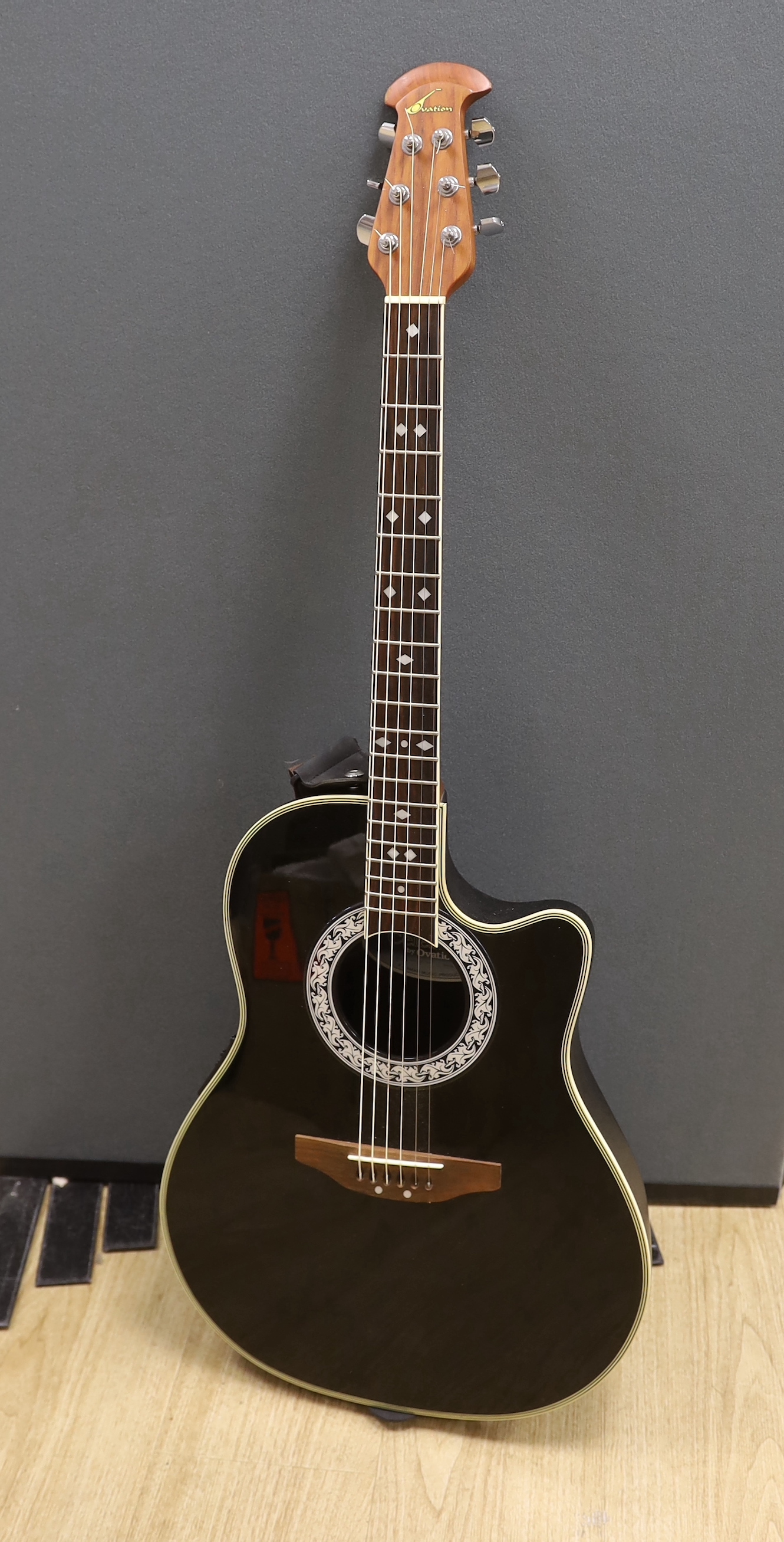 A Celebrity by Ovation electro-acoustic round back guitar with hard case